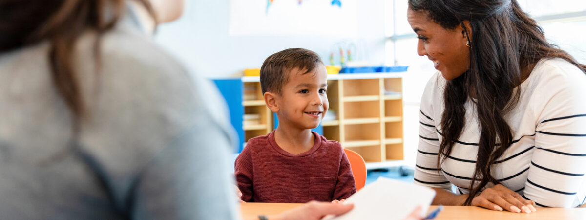 Child and parent with teacher